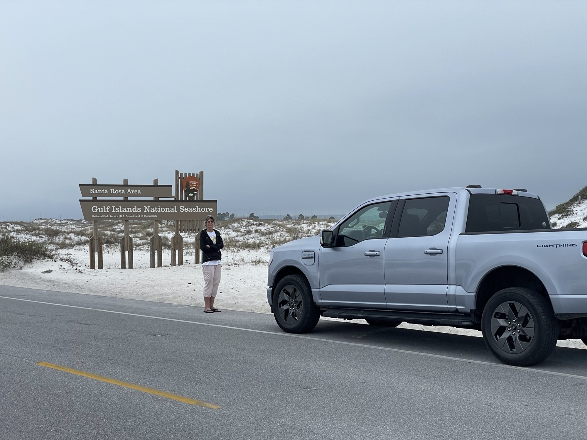 June Eakin and Sherman the F-150® Lightning® at the entrance to Gulf Islands National Seashore.
